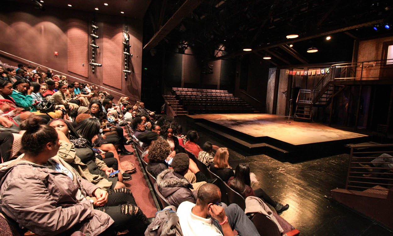 Front row patrons enjoy a view of the stage.