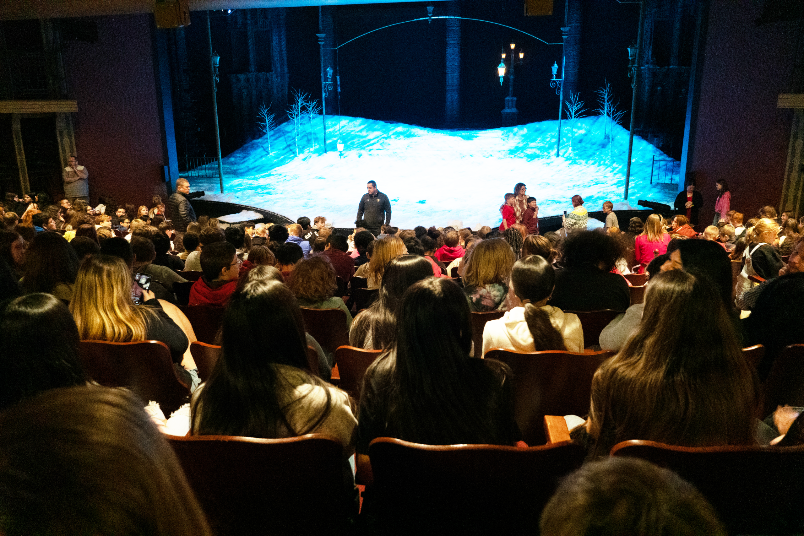 Students getting ready to watch a production of A Christmas Carol on the OneAmerica Financial Stage at the IRT.